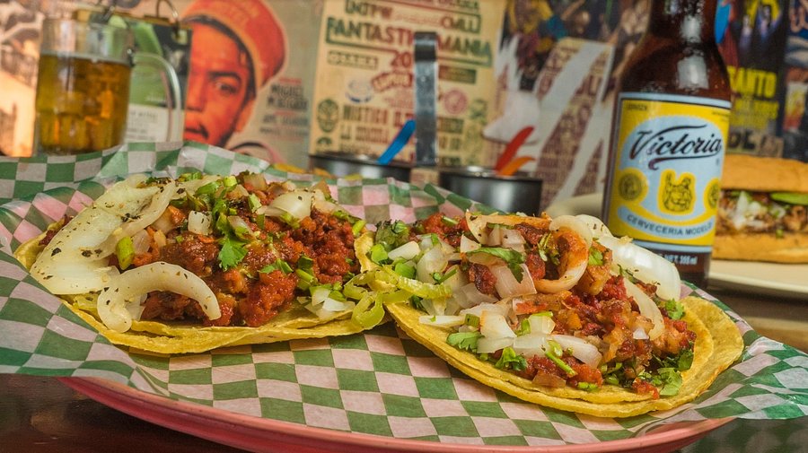 Taqueria Coapeñitos signature dishes Tacos al Pastor, Coapeñito (suadero, chorizo, chicharrón), Azteca (steak, nopales, grilled onions), Chilaquiles Coapeños.